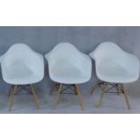 Three Eames style moulded tub armchairs. H.80cm