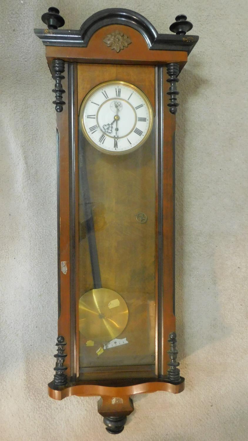 A 19th century walnut and ebonised cased Vienna regulator wall clock the enamel dial with Roman