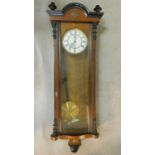 A 19th century walnut and ebonised cased Vienna regulator wall clock the enamel dial with Roman