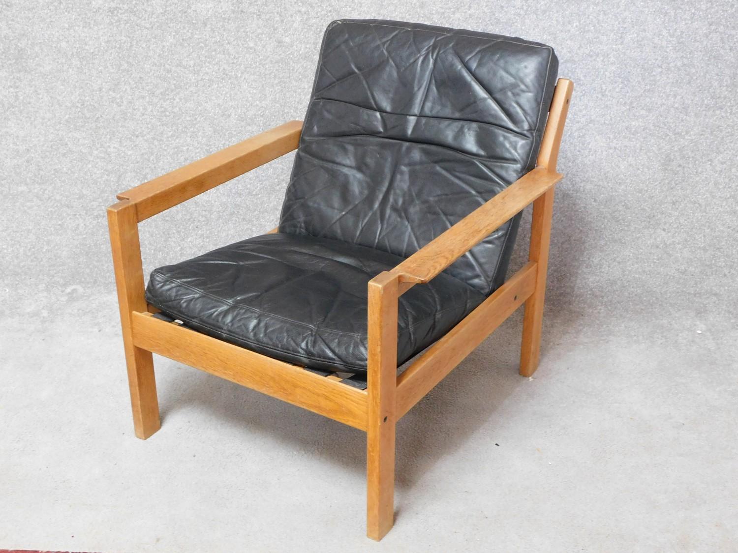A mid century vintage teak framed armchair with black leather seat and back cushions. 77x70cm - Image 3 of 3
