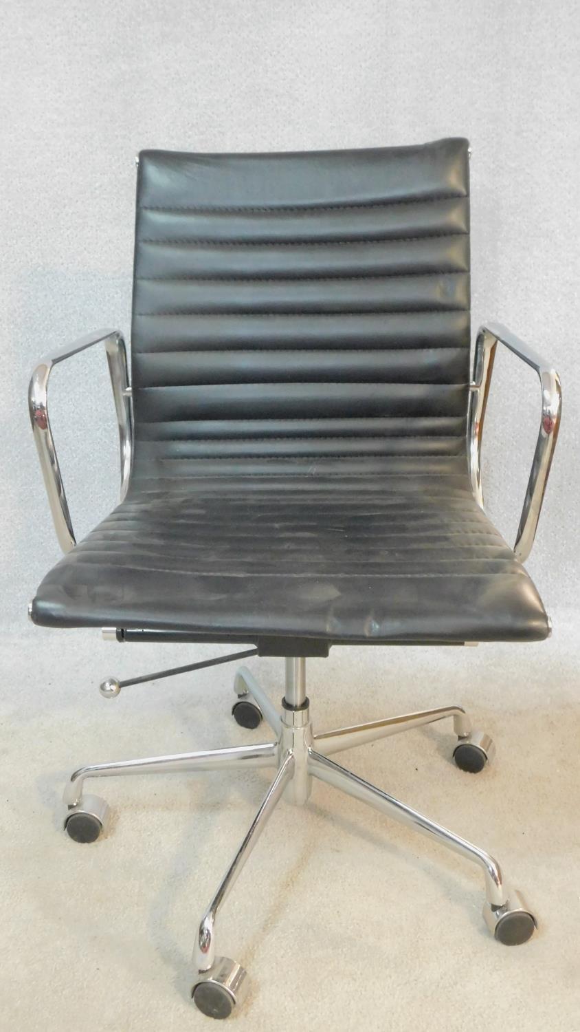 A vintage Charles and Ray Eames inspired Aluminium Group style office desk armchair in black