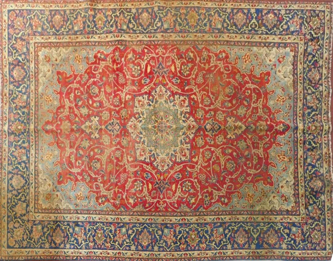 An antique Isfahan carpet with double central medallions on burgundy field with all over scrolling