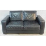 A contemporary two seater sofa in black leather by Natuzzi. H.80 W.160 D.90cm
