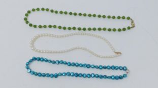 A blue cultured pearl necklace with silver ball push clasp, a serpentine and cultured pearl necklace