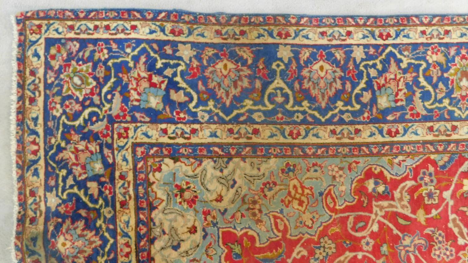 An antique Isfahan carpet with double central medallions on burgundy field with all over scrolling - Image 3 of 4