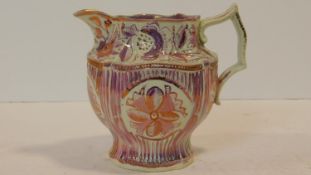 A 19th century pink lustreware jug with abstract floral design. Makers mark to the base. H.14cm