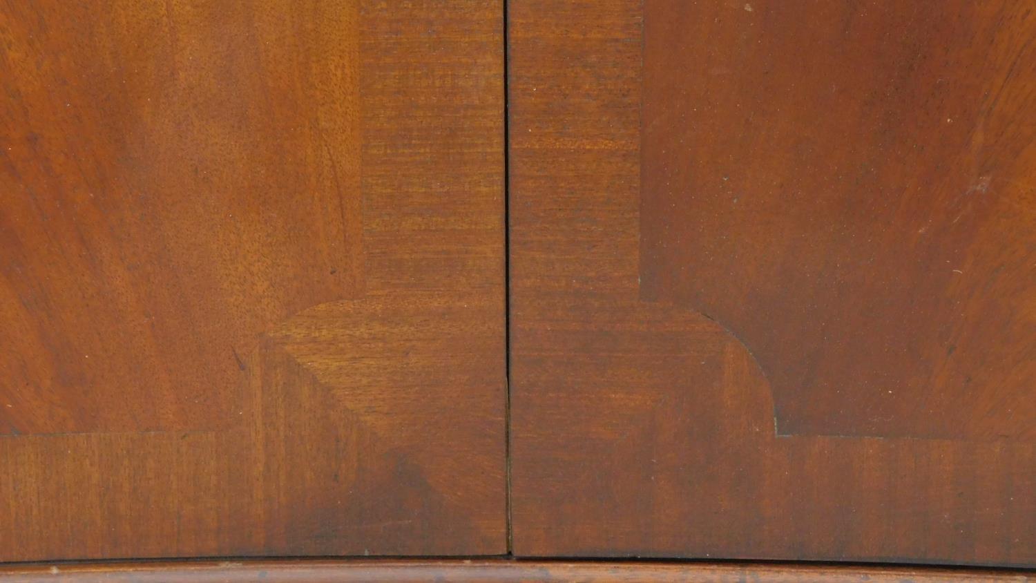 A Georgian style flame mahogany corner cupboard of concave outline with astragal glazed section - Image 6 of 7