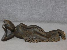 An early to mid 20th century Burmese carved hardwood reclining Buddha. With intricately carved