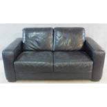 A contemporary two seater sofa in black leather by Natuzzi. H.80 W.160 D.90cm