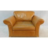 A contemporary armchair in light tan leather upholstery. H.90 W.130 D.100cm