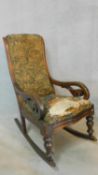A Victorian mahogany framed rocking armchair in tapestry style upholstery. H.100 W.53 D.90cm