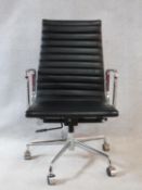 A Charles and Ray Eames Aluminium Group style office desk armchair in black ribbed leather