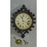 A late Victorian single fusee dial wall clock in a Gothic carved mahogany case, makers label Geo