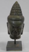 A Southeast Asian carved hardstone head of Vishnu with serene face, open eyes, elongated earlobes,