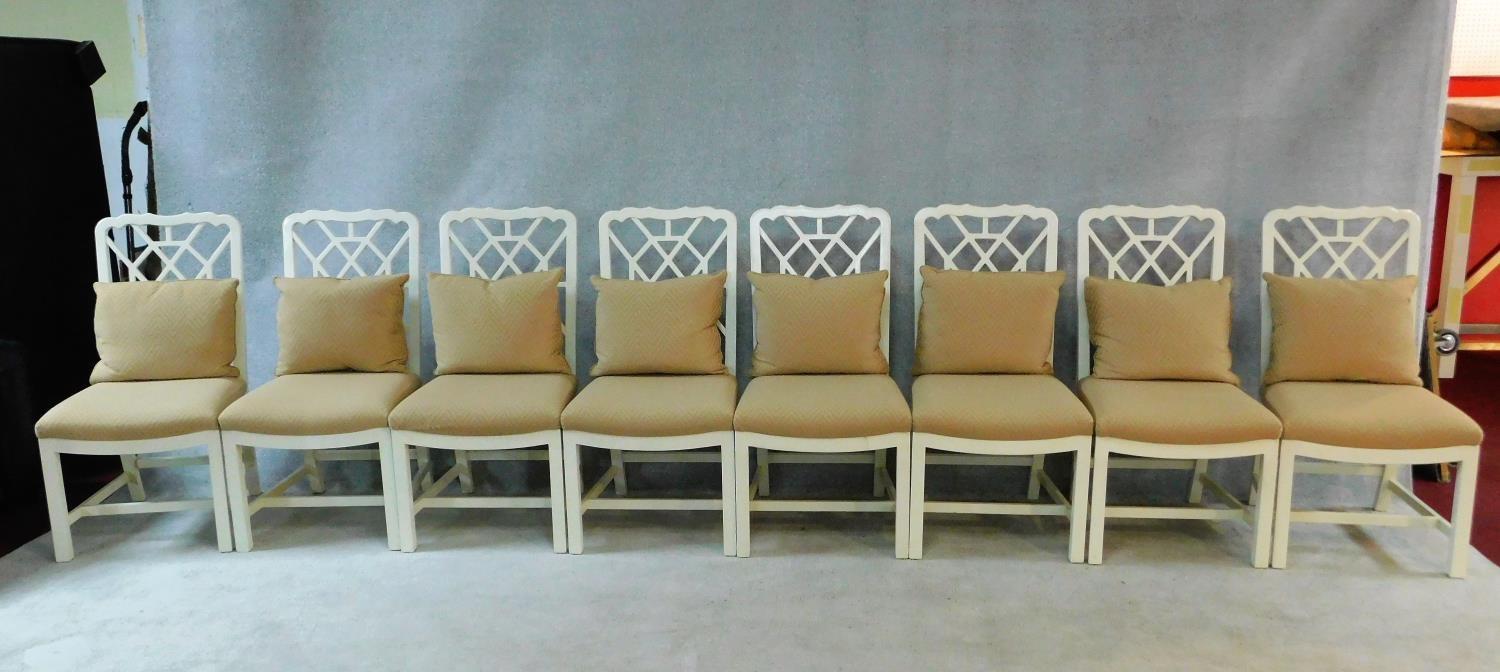 A set of eight white painted Chinese Chippendale style dining chairs with beige upholstered
