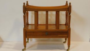 A mahogany 19th century style Canterbury fitted with base drawer on turned tapering supports. H.53