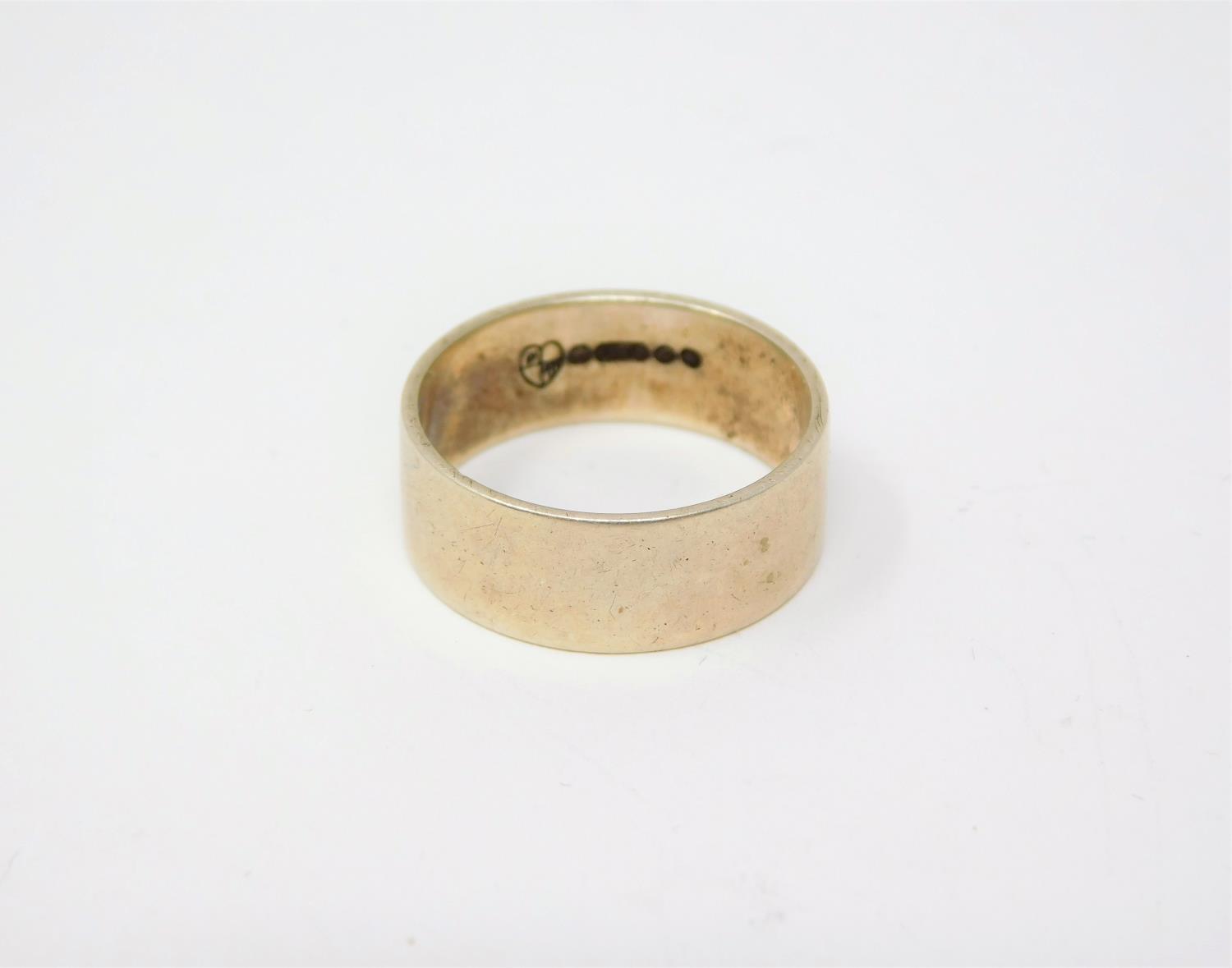 A 9ct yellow gold flat band, hallmarked 375, makers mark FW in a quartered heart for F. Mansure
