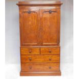 A mid 19th century well figured mahogany linen press with fielded panel doors enclosing linen slides