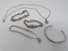 A collection of silver jewellery. Including a silver charm bracelet with heart padlock, a rainbow