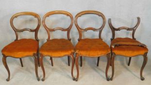 A set of four 19th century rosewood balloon back dining chairs on carved cabriole supports. H.86cm
