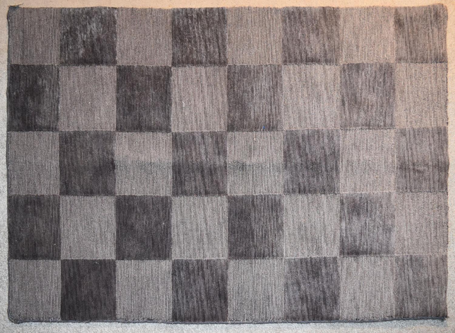 A contemporary rug with grey chequerboard pattern. L.144x94cm