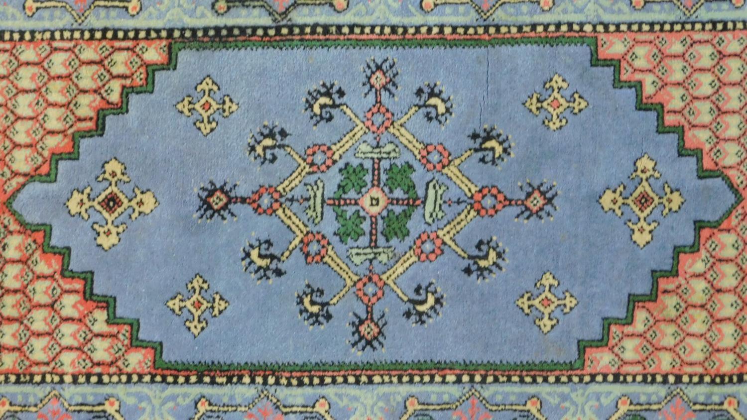 A Samarkand rug with central lozenge medallion on pale blue ground within a naturalistic floral - Image 2 of 4
