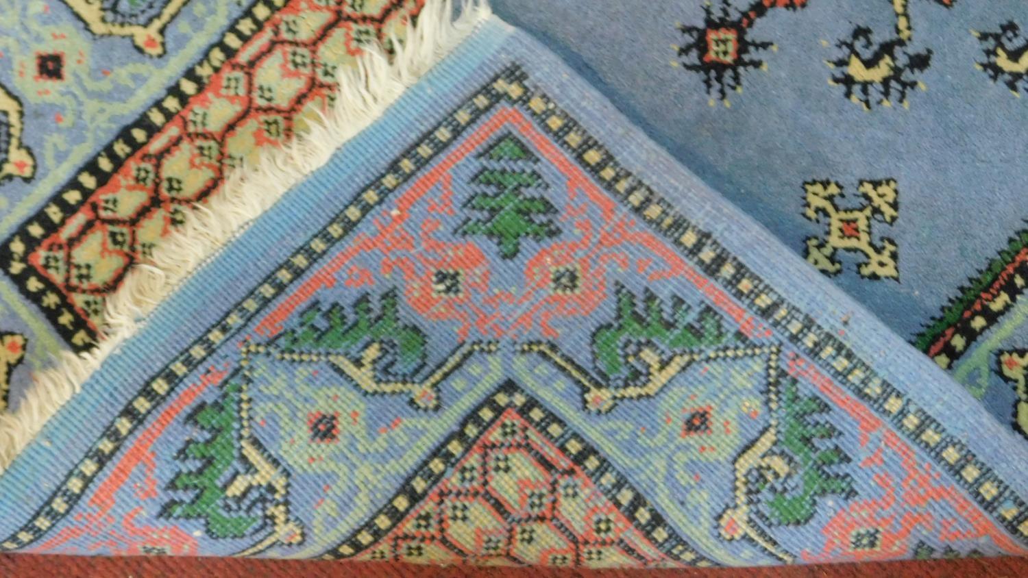 A Samarkand rug with central lozenge medallion on pale blue ground within a naturalistic floral - Image 4 of 4