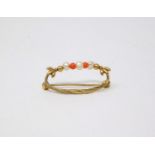 An antique 9 ct yellow gold foliate wreath design brooch threaded with natural pearls and coral