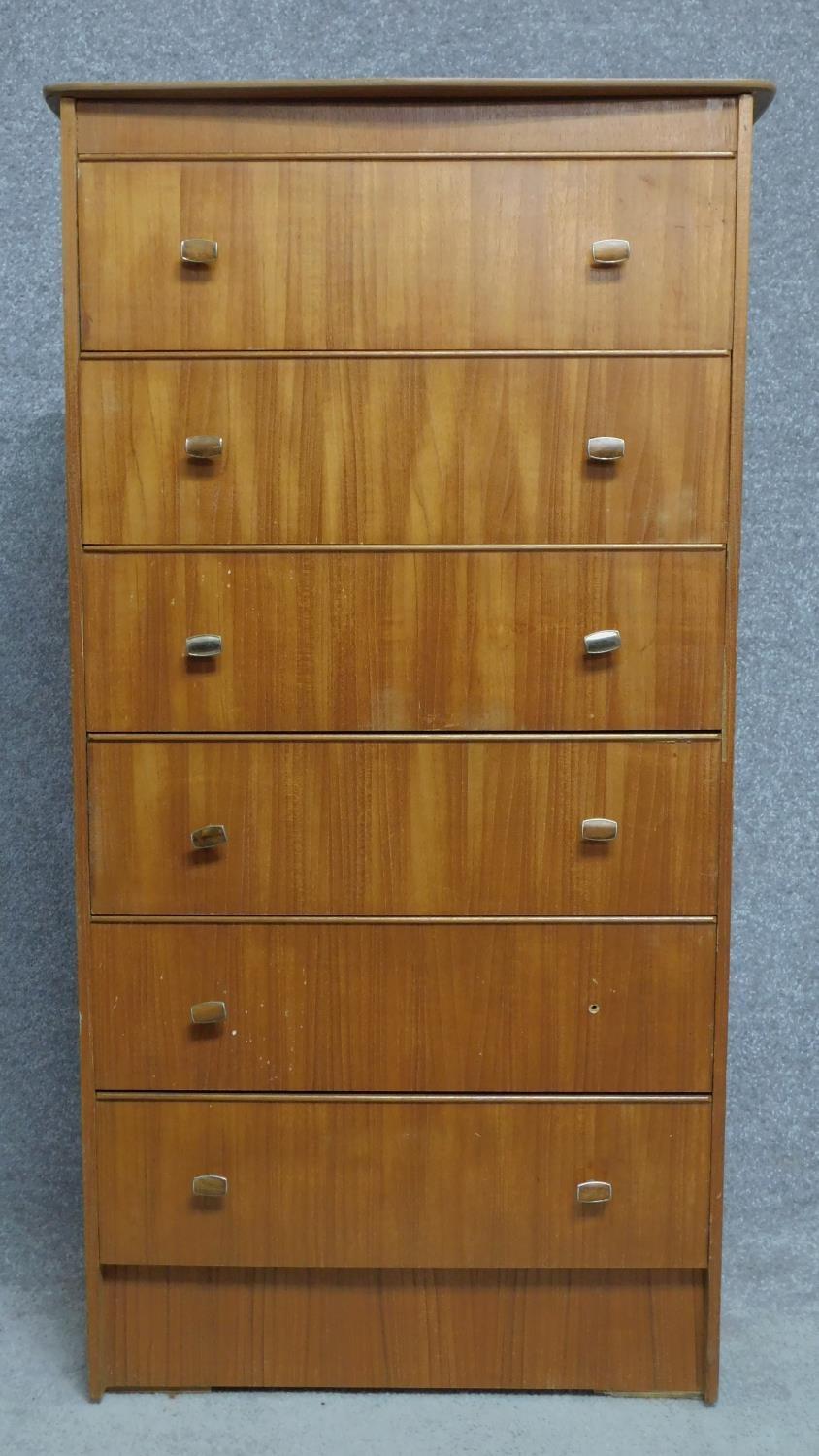 A mid century vintage teak tallboy chest of six drawers. H.126 W.67 D.42cm