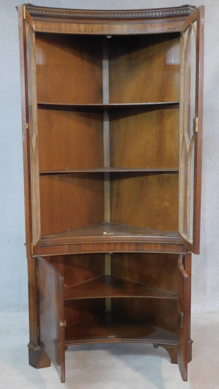 A Georgian style flame mahogany corner cupboard of concave outline with astragal glazed section - Image 2 of 7