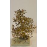 A vintage brass and agate tree on a stone slab base. The leaves are each chips of various coloured
