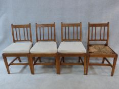 A set of four antique country elm dining chairs with carved rail backs and rush drop in seats. Three