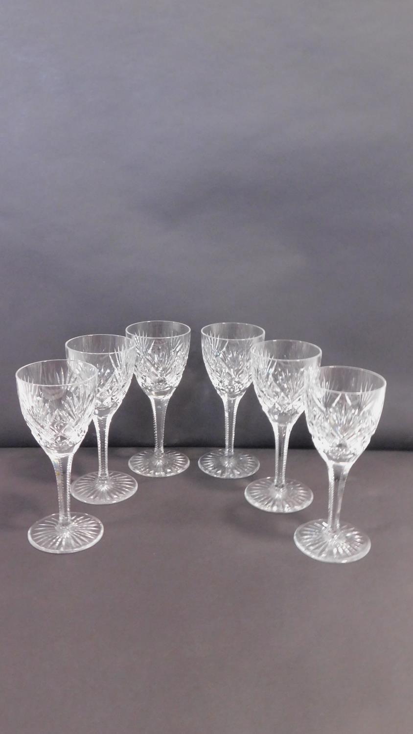 A set of six star cut heavy lead crystal small sherry glasses with star cut design to bases and