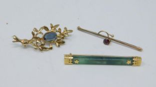 Three antique yellow metal brooches. One with a foliate design set with mixed cut garnet, hallmarked