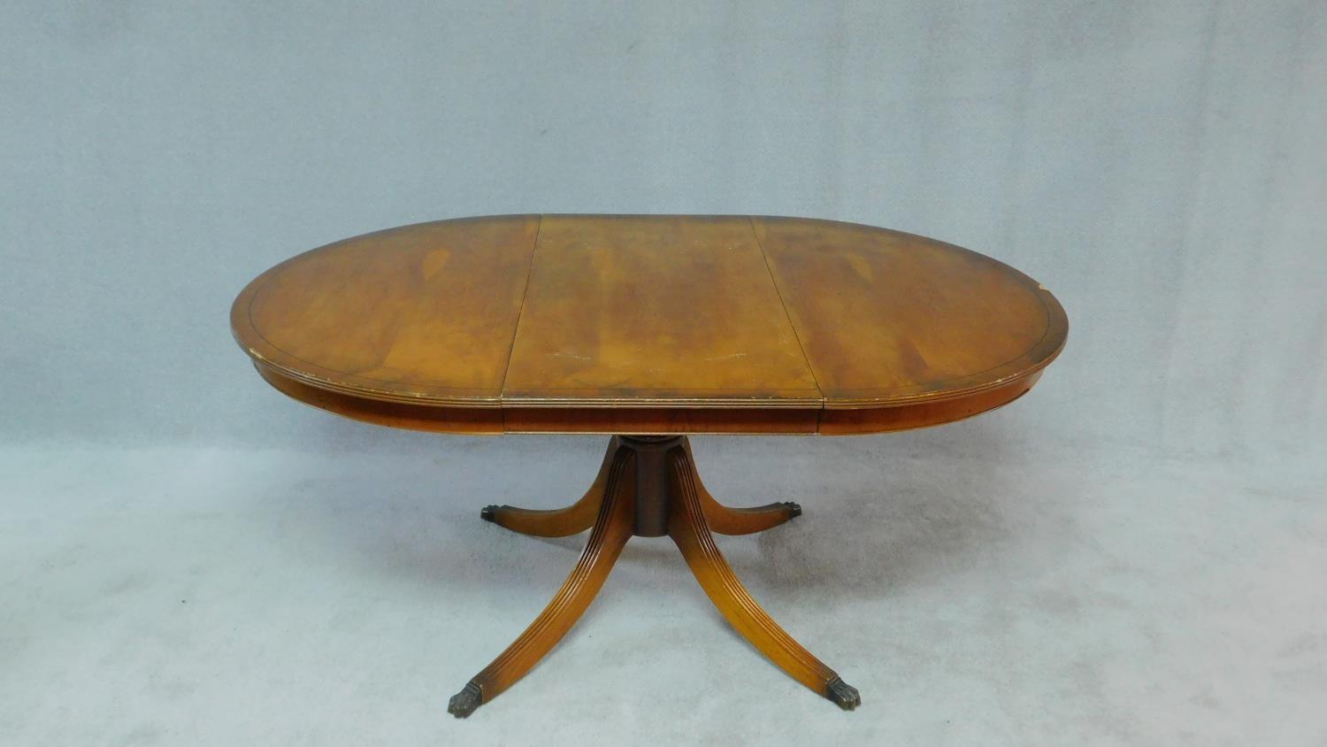 A Georgian style yew wood dining table with extra leaf on quadruped swept supports. H.73 W.160 D.