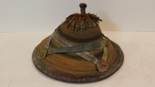 An African Fulani hat of conical form from woven fibres and leather. D.40cm