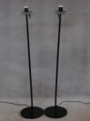 A pair of metal floor standing uplighters with opaque shades. H.133cm