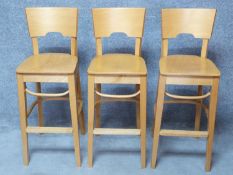 A set of three contemporary beech high chairs. H.110cm