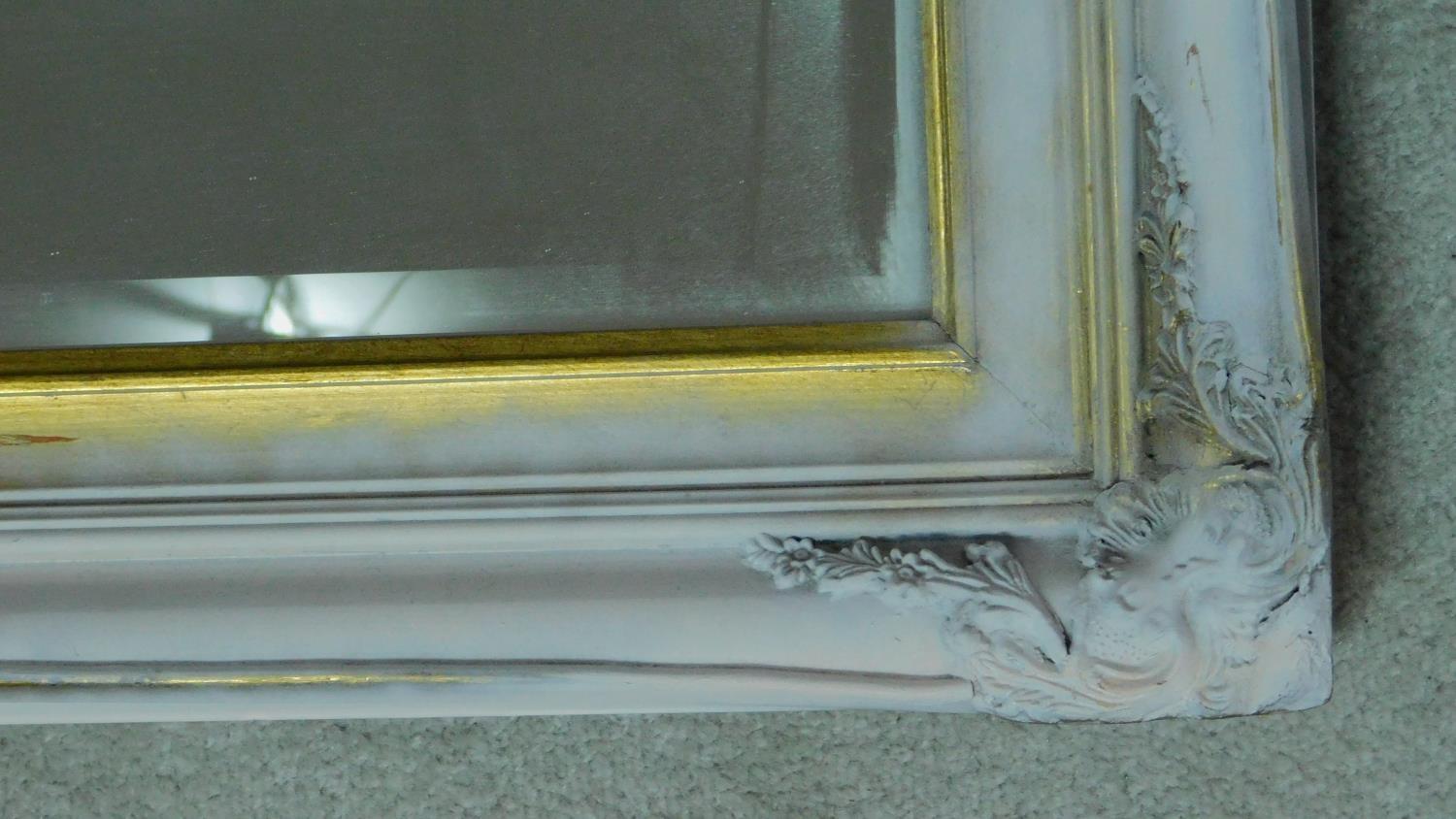 A large rectangular wall mirror in a distressed painted and gilt frame fitted with bevelled plate. - Image 2 of 2