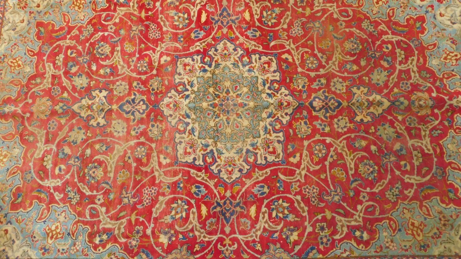 An antique Isfahan carpet with double central medallions on burgundy field with all over scrolling - Image 2 of 4