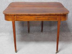 A Georgian mahogany, crossbanded and satinwood strung console or tea table with foldover top and