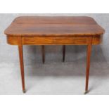 A Georgian mahogany, crossbanded and satinwood strung console or tea table with foldover top and