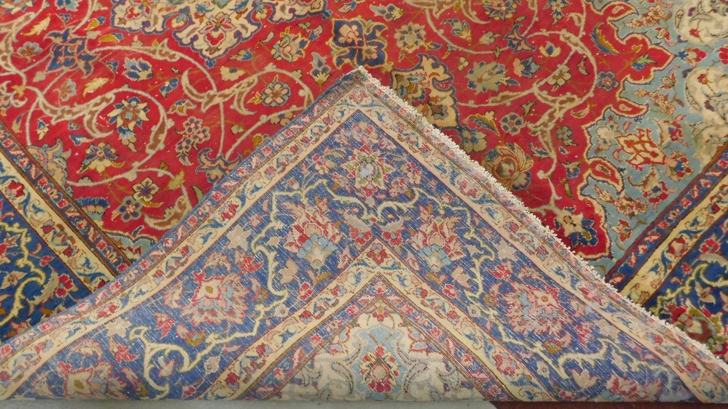 An antique Isfahan carpet with double central medallions on burgundy field with all over scrolling - Image 4 of 4