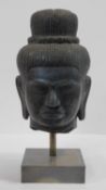 A Southeast Asian carved hardstone head of Vishnu with serene face, open eyes, elongated earlobes,