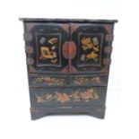 An early 20th century Japanese gilded lacquer table top cabinet with drawers decorated with flower