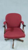 A vintage Georgian style office desk armchair in burgundy cut moquette with swivel and tilting