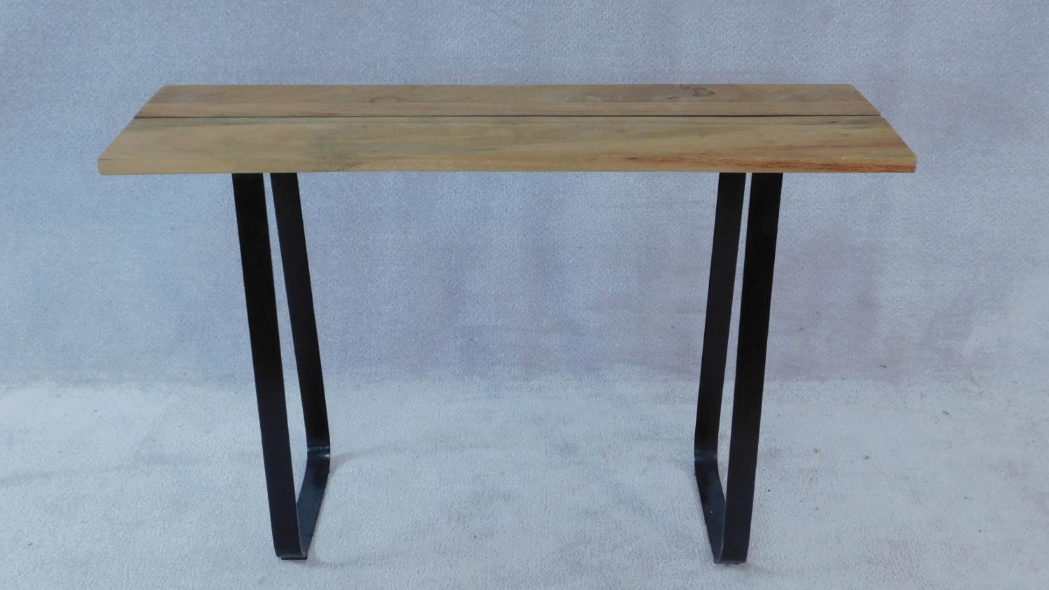 An Eastern hardwood planked top console table on wrought metal base. H.80 W.120 D.36cm