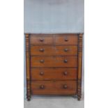 A Victorian mahogany chest of two short over four long drawers flanked by pilasters on turned