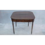 A 19th century flame mahogany tea table with fold over top on turned tapering supports. H.74 W.91cm