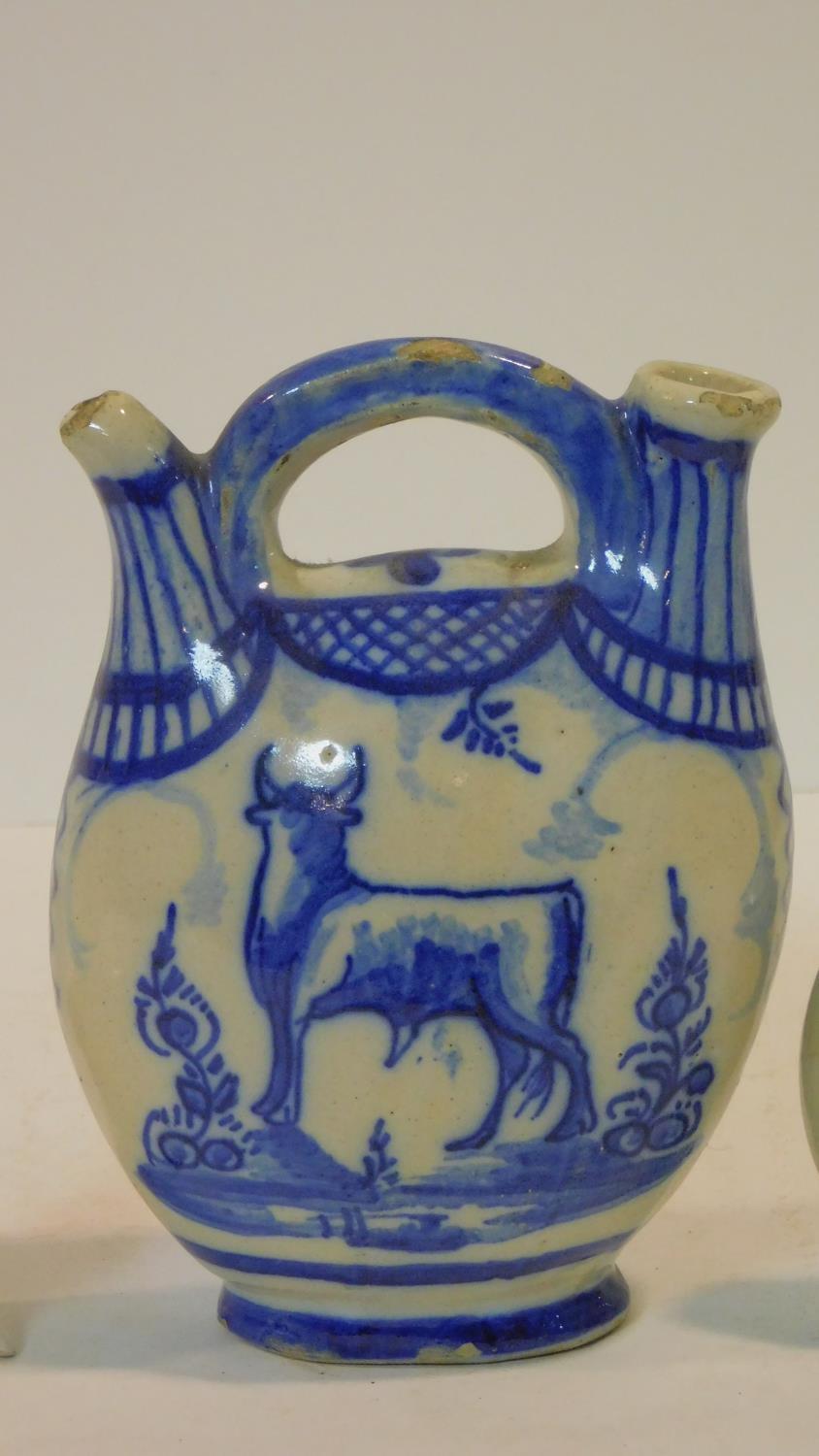 A collection of antique ceramic items. Including a blue and white Delft twin spout jug with cow - Image 3 of 7